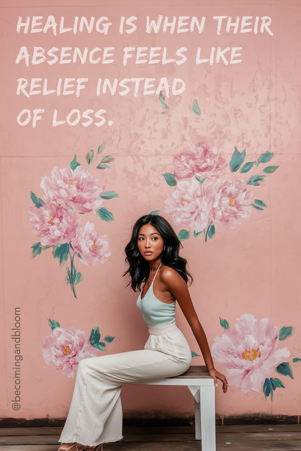 A woman with a peaceful mindset sits on a bench against a pink, floral-painted wall, where the quote Healing is when their absence feels like relief instead of loss is inscribed. Dressed in a white top and beige pants, she reflects on why inner peace is more powerful than proving a point.