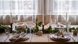 A serene morning scene with golden sunlight streaming through sheer curtains onto a beautifully arranged breakfast tray holding a French press, linen napkin, and single fresh flower in a bud vase. The scene conveys affordable luxury through thoughtful presentation rather than expensive items. --ar 16:9